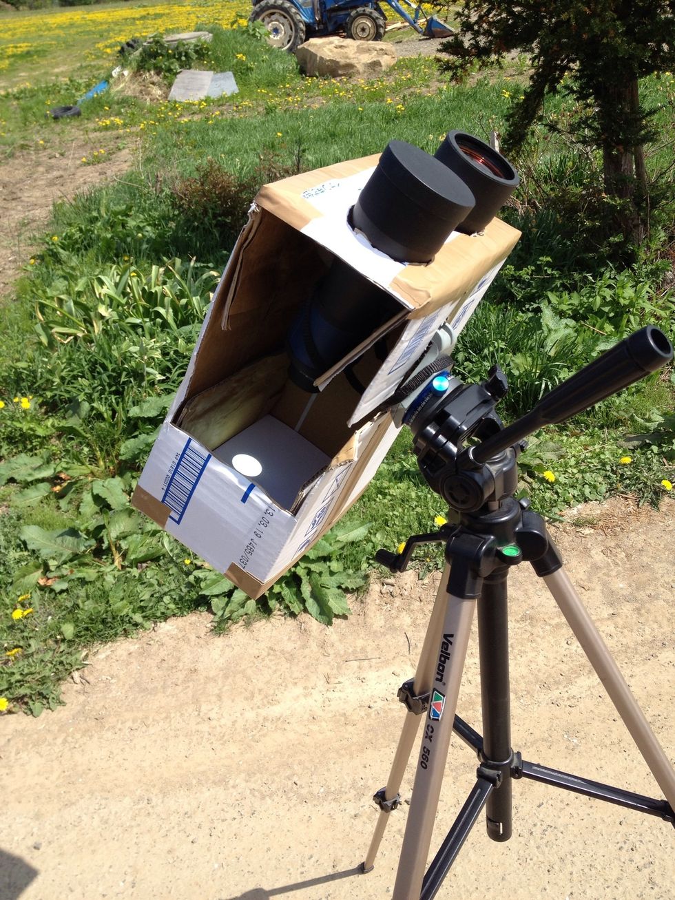 The hole in the side lets you put the binoculars in and lets you see the projected image of the sun on the back side of the box.