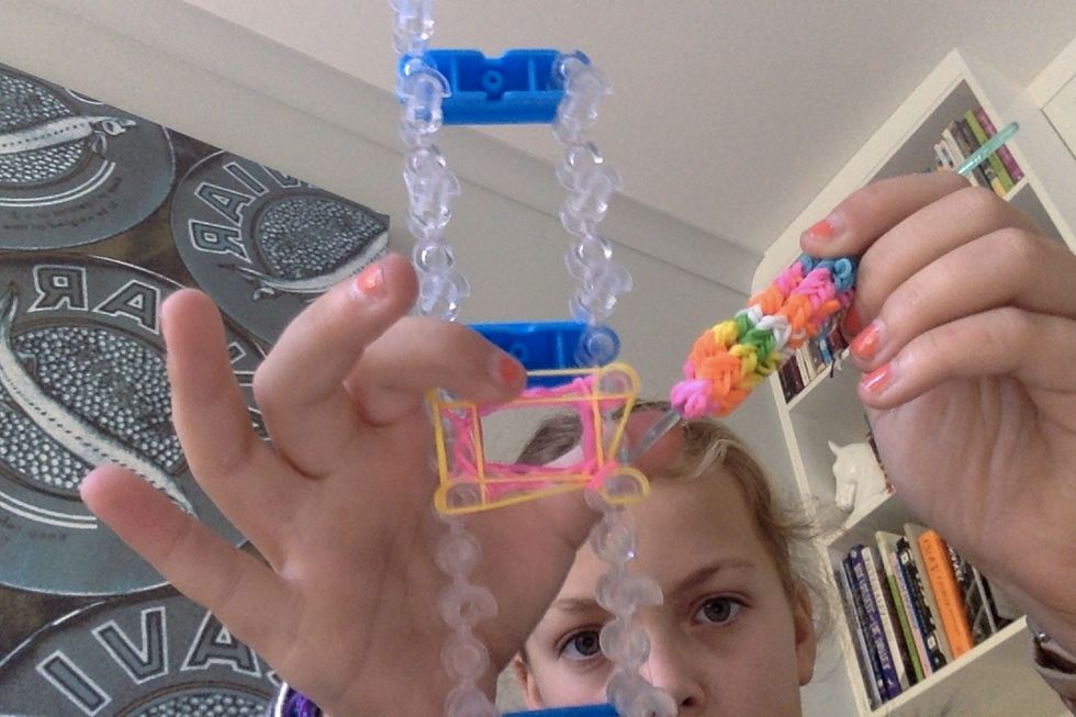 The hook the bottom two around over the peg and drop it.