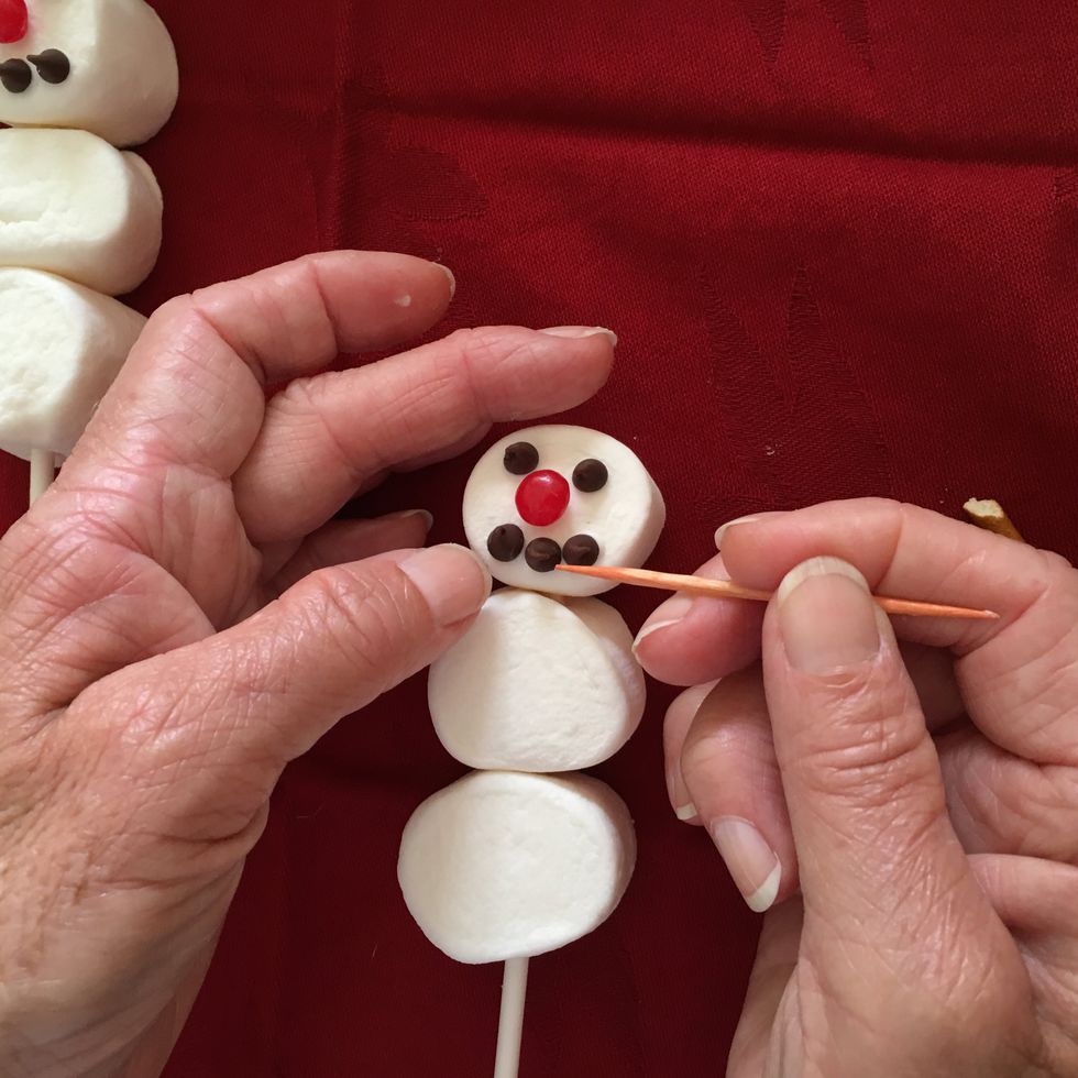 The icing sets up quickly but you can use a toothpick to move things into place if desired.