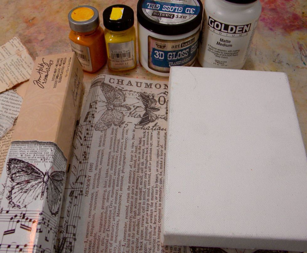 The idea is to create interesting layers, so I started with Tim Holtz pretty tissue paper and adhered it to my canvas using matte medium. It's important to let every layer dry completely.