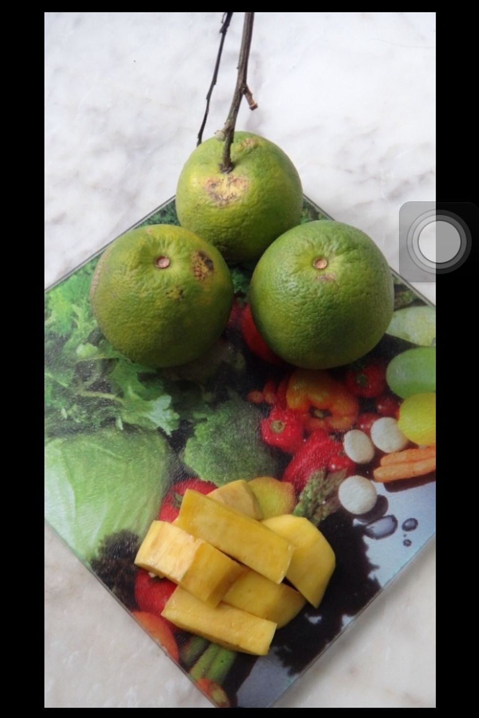 The ingredients you'll need are: three oranges and half a mango. These quantities fit half of my ice cube tray.