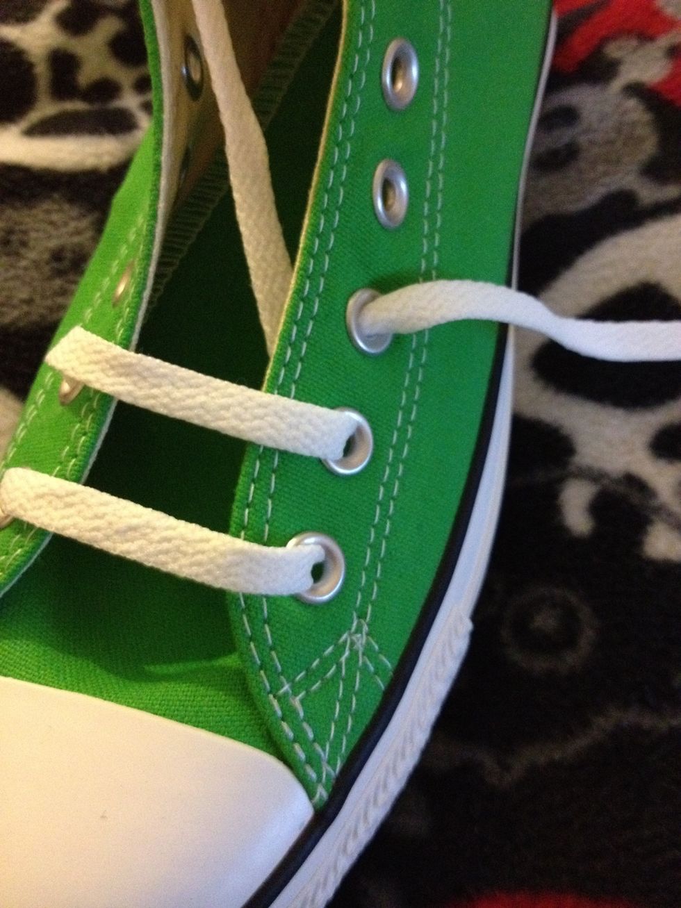 The inside lace now goes over the sneaker and back in the second eyelet.