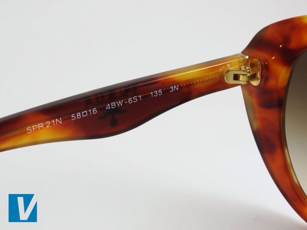 The inside left temple of Prada sunglasses feature the model number - sunglasses start with an "S" and eyeglasses start with a "V";; and sets of numbers representing the lens width and the nose width.