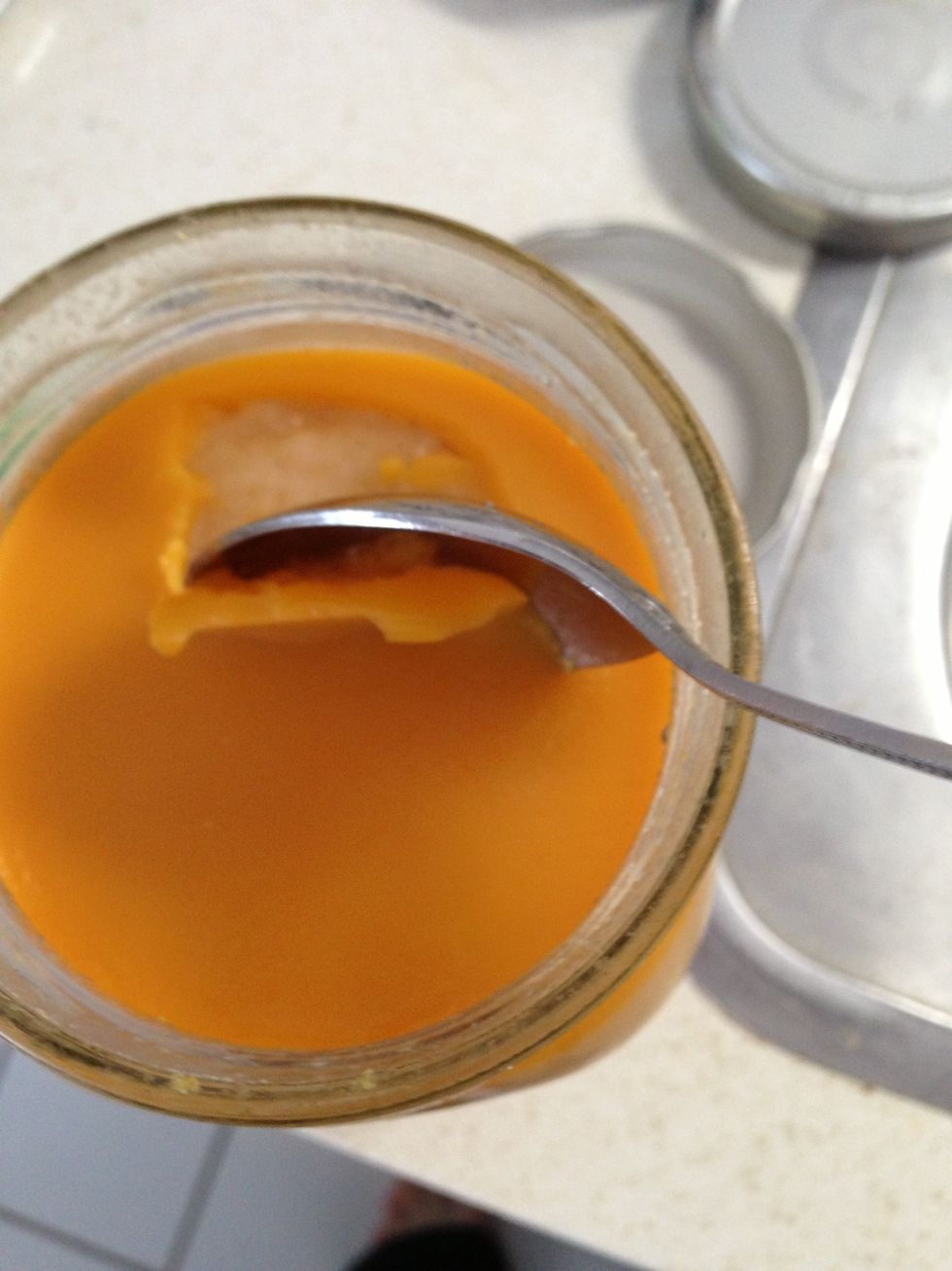 The jars are sealed with the first waxy layer of fat. Scrape if off and discard.