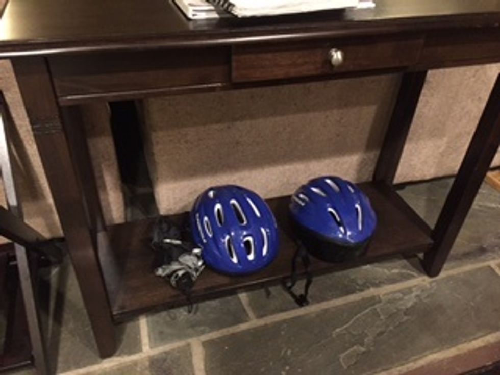 The key to the locks and the helmets are generally under the table in the hideaway.