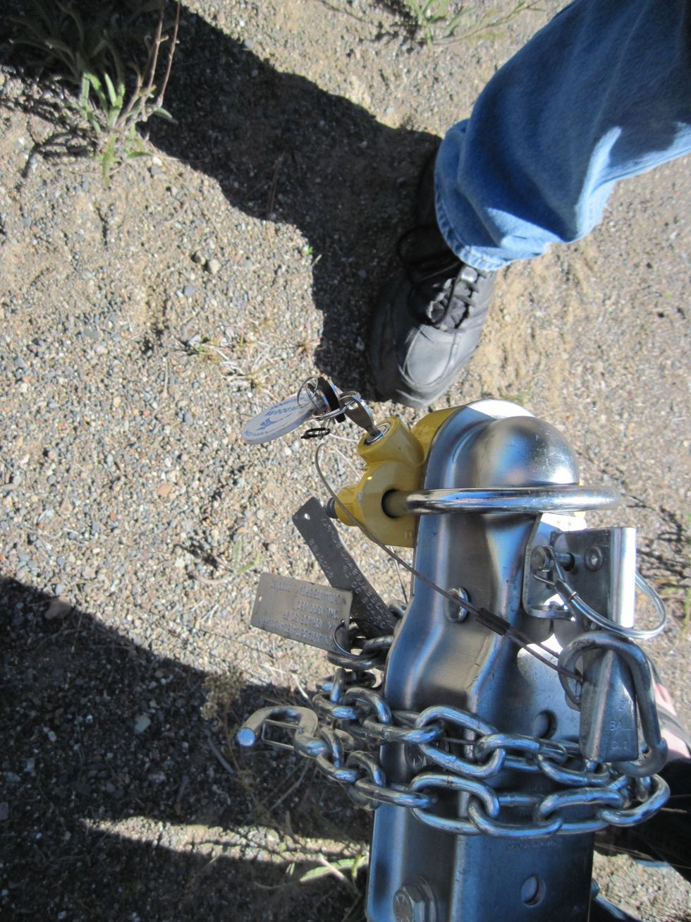The key will free up the horseshoe shaped piece and yellow block. Save the hitch lock in your trailer.