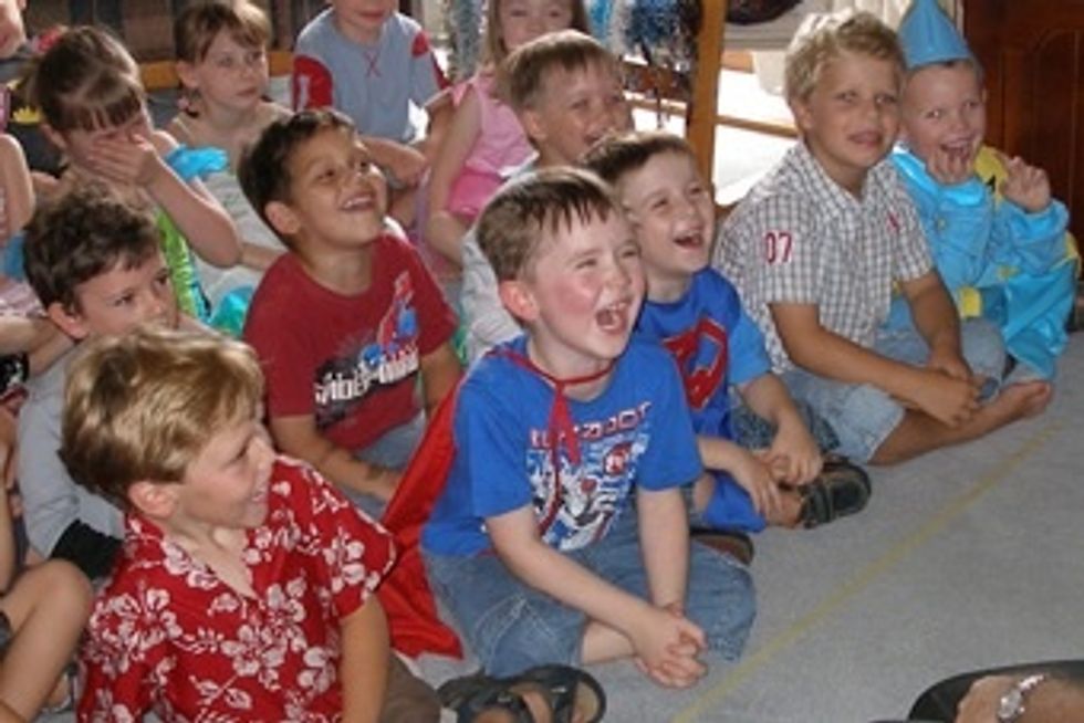 The kids should enjoy the show. It's the parents job to gather the children and get them to anticipate the entertainment they've provided by hiring the magician.
