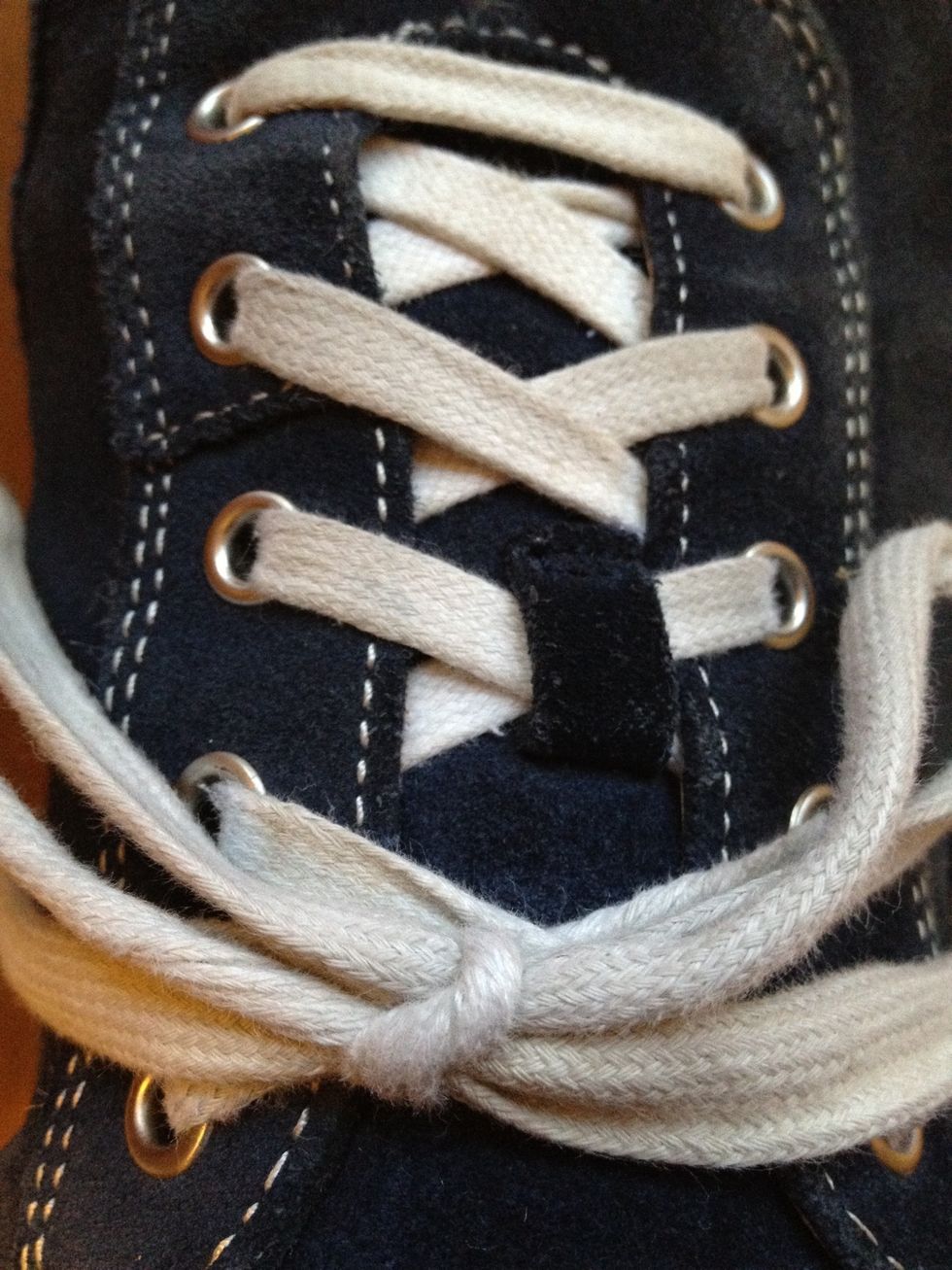 The laces should lay parallel to one another. And should stay tied all day!