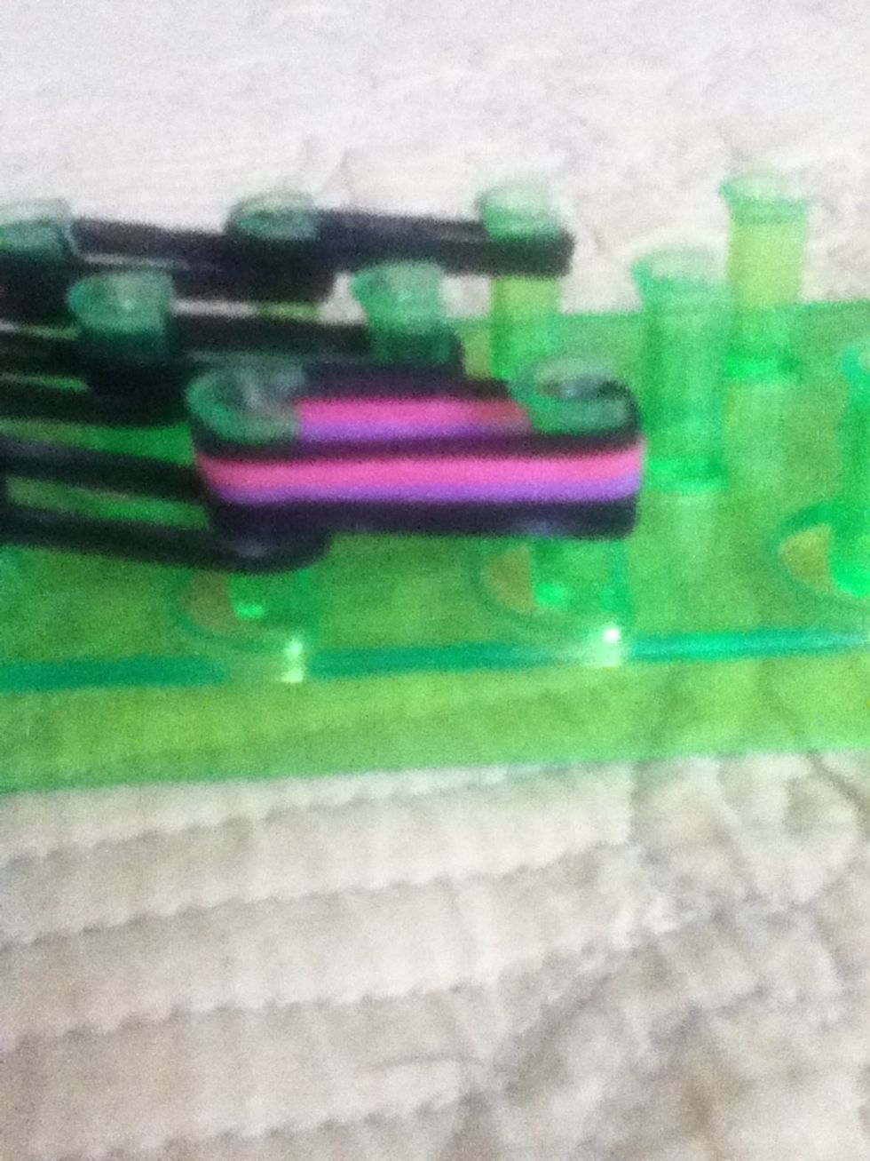 The last 2 rubber bands you placed on the left your going to put 3 rubber bands on top of it repeat with the other 2 sides