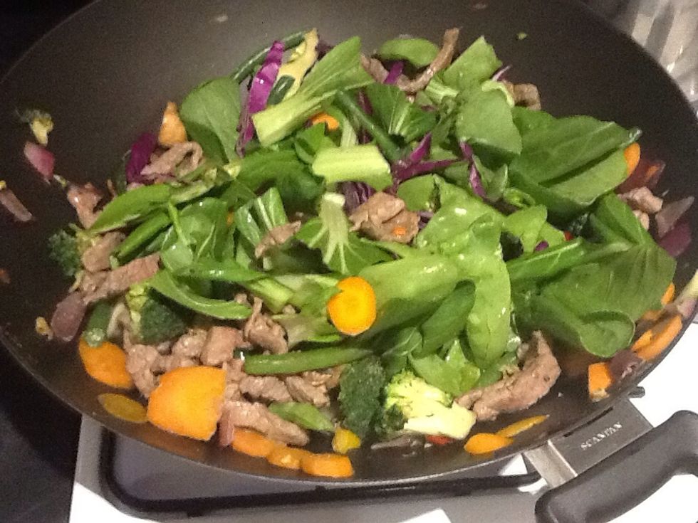 The last step is to add the quicker cooking vegetables.  Continue to cook until the Bok Choi is moist