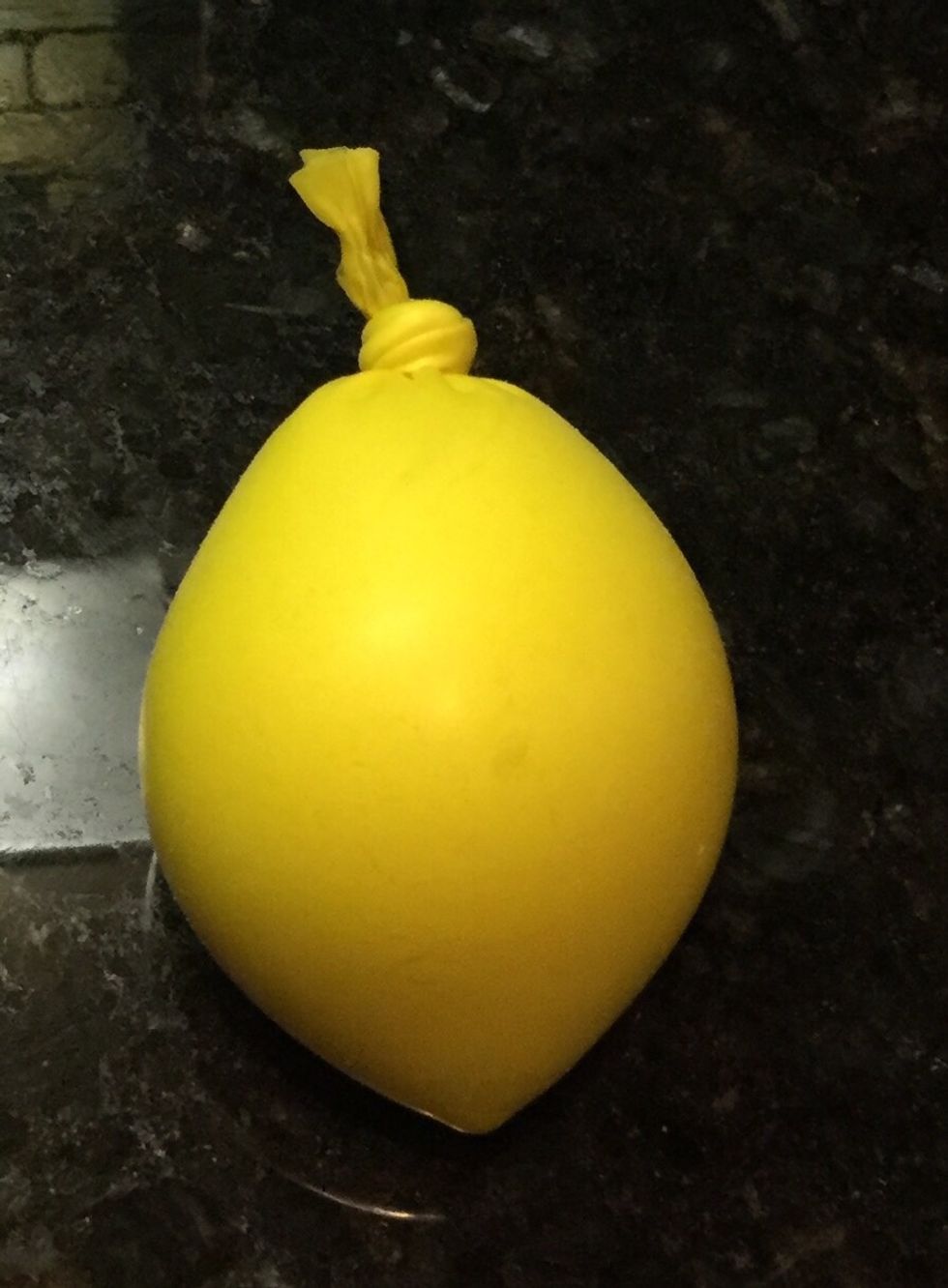 The last step is to take the funnel out of the balloon and tie your balloon.