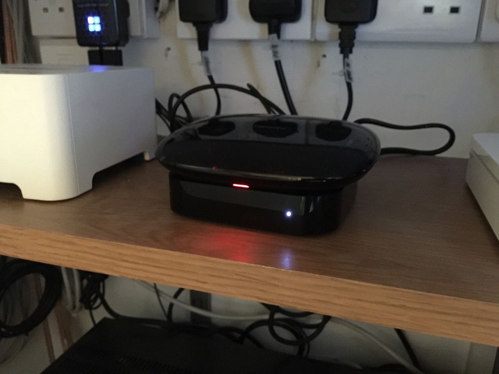 The light on the Harmony Base Station will be red while it is booting up. It will turn green when it's done.