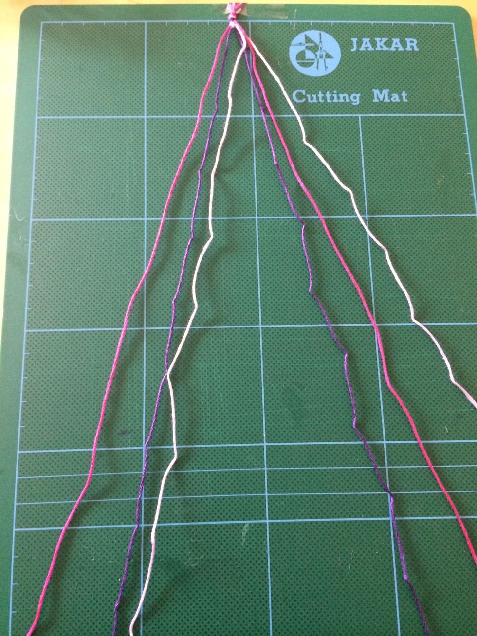 The lilac thread is now in the third position from the left.