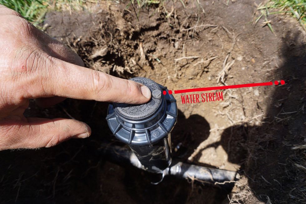 The little black arrow denotes the water stream. It's time to align that arrow to aim to the furthest right (clockwise) you need it to go and stop. We will also do this by unscrewing the guts.