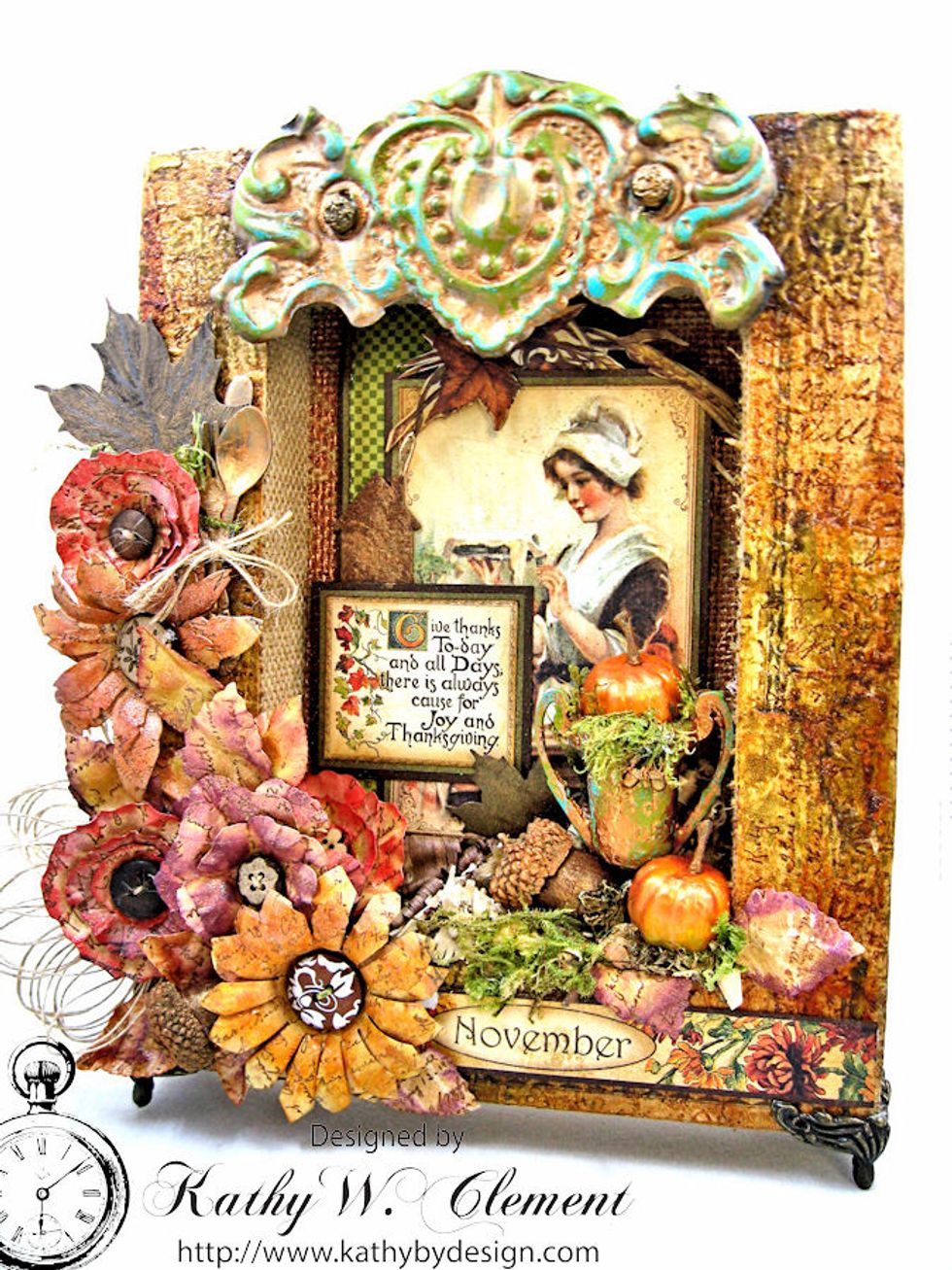 The metal piece is an antique tin curtain tie back. I painted this with copper texture paste and added vintaj patina to make it match my color palette. The little box feet add a finishing touch.