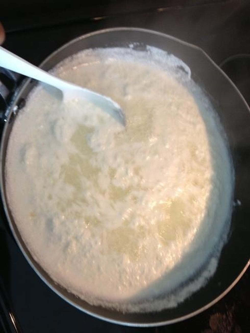 The milk will begin to separate into a thin greenish liquid and paneer. Watch this process carefully as milk begins to overflow very quickly when boiling.