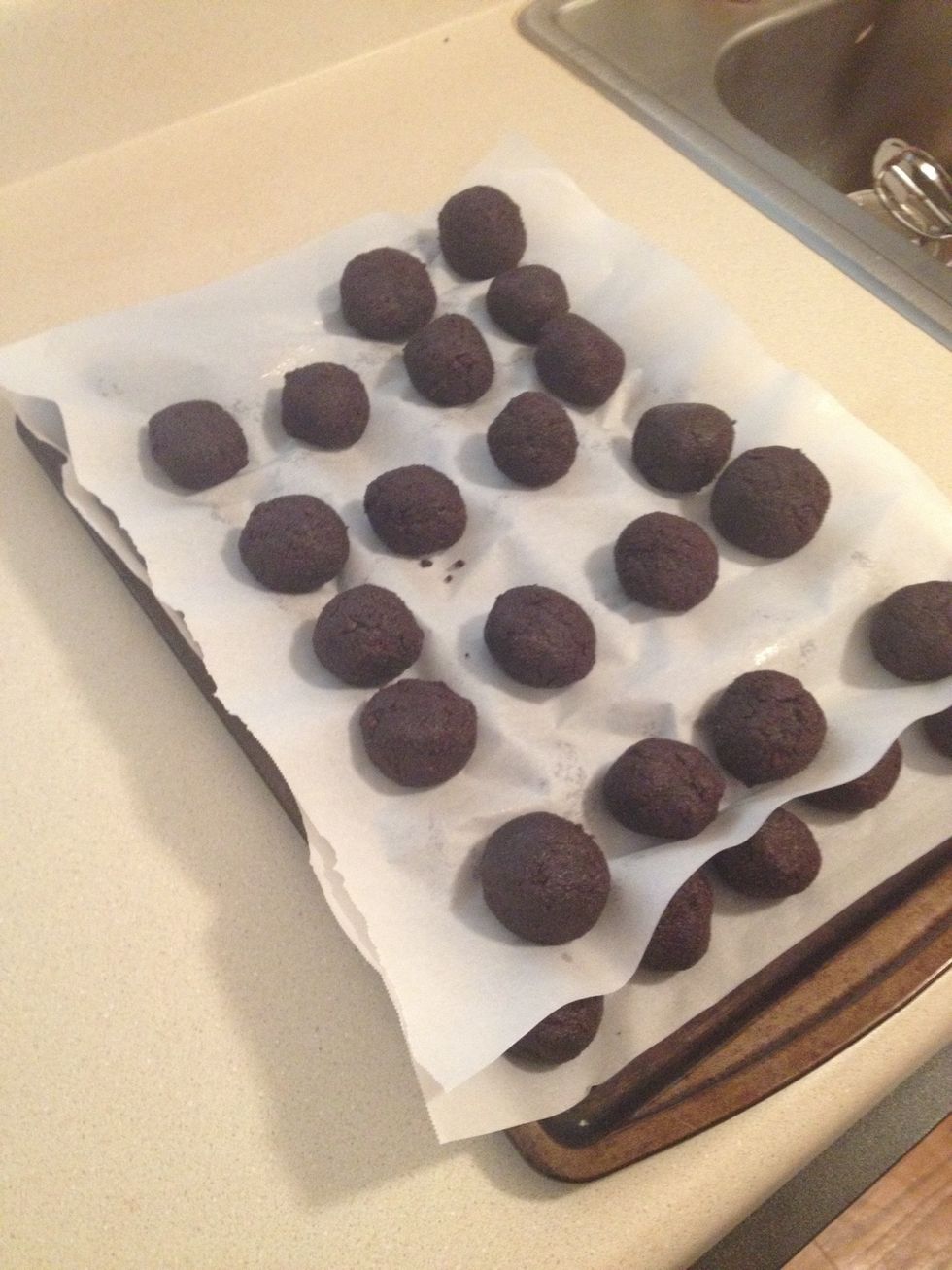 The mixture should be moist enough to Roll into 1 1/2 inch balls and still hold a round shape. After rolling the cake balls by hand, place them on a wax paper-covered baking sheets.