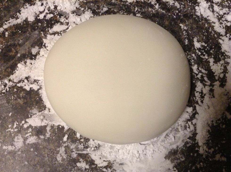 The mixture should start to get smoother and smoother. If it feels too sticky measure out another half a cup of powdered sugar and add a few table spoons from that. Don't add too much! Form into disk