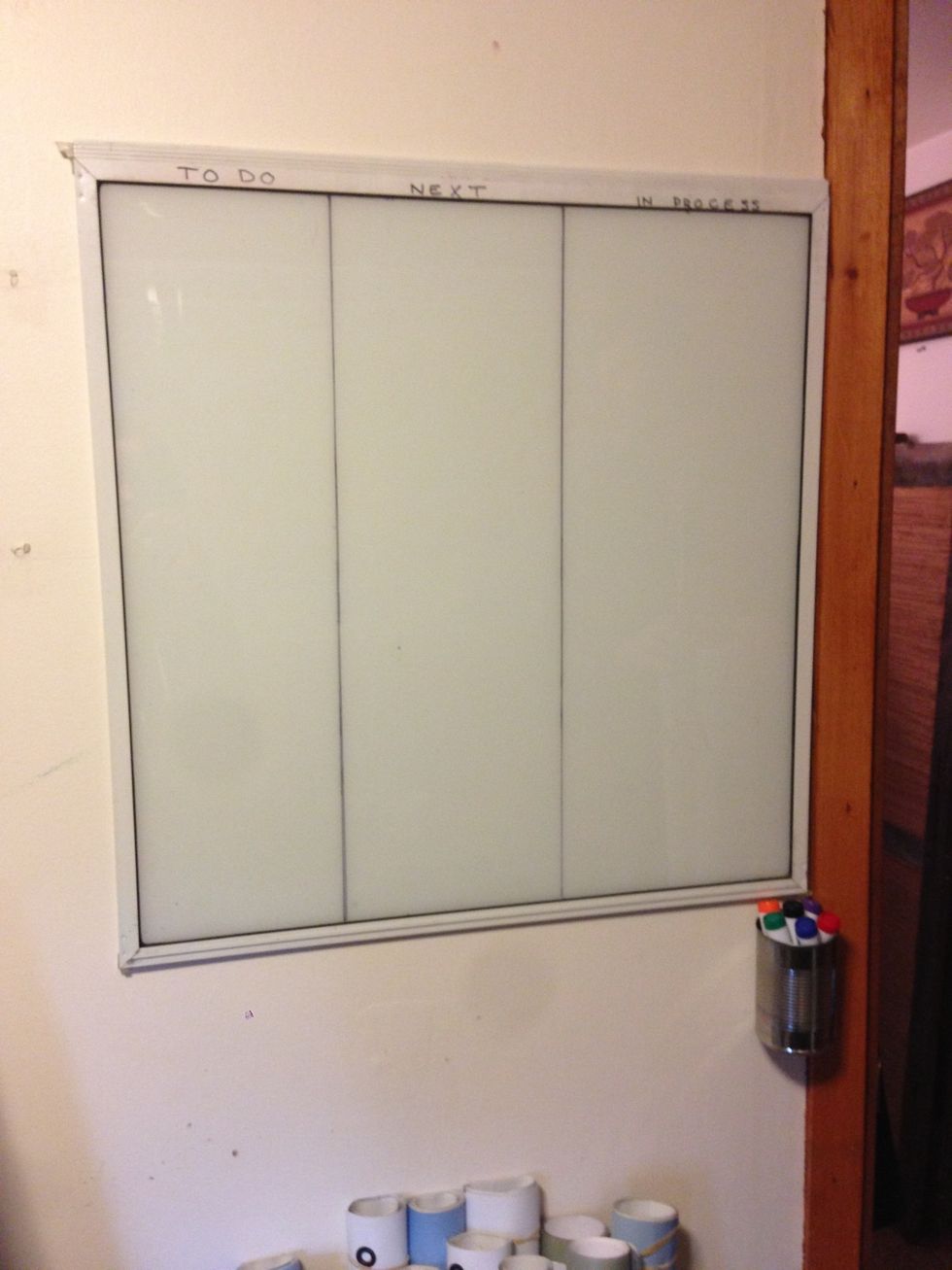 The mounted whiteboard. Notice our handy Upcycled dry erase marker holder.