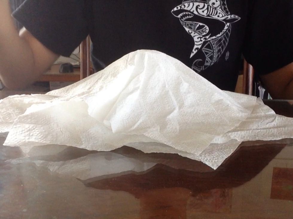 The napkins should stay dented making the illusion that the ball is still there.