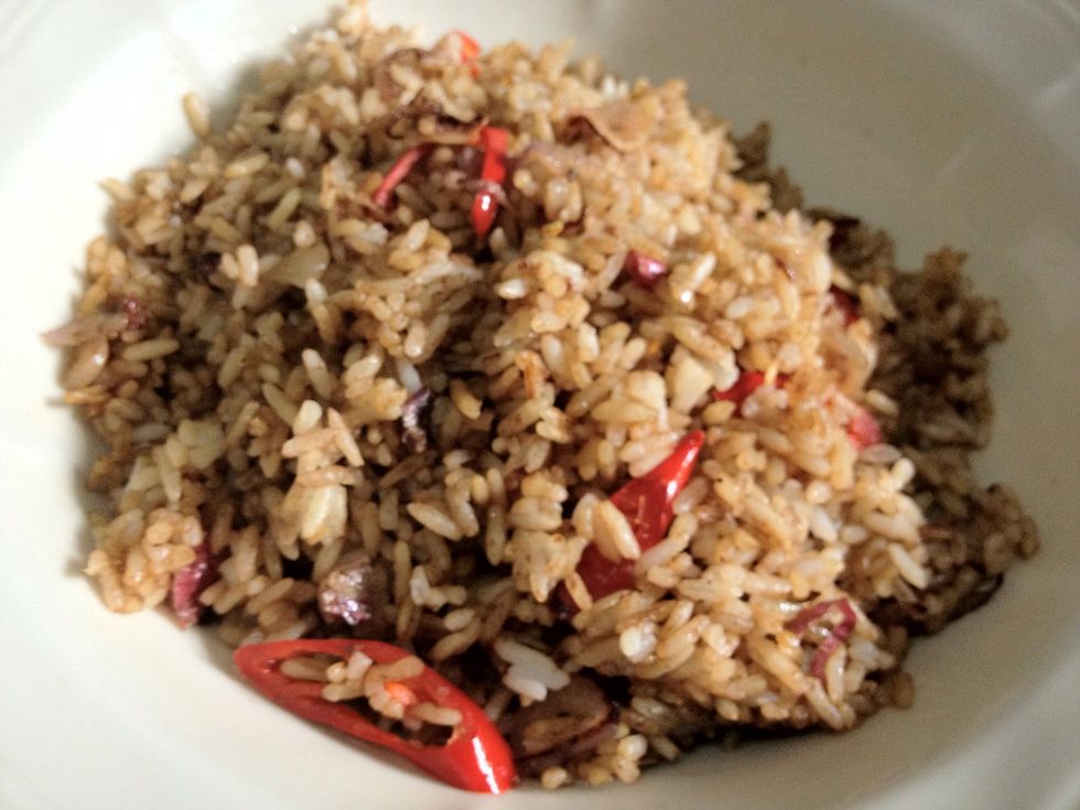 The nasi goreng! Put in a prepared bowl. What about the chicken? The chicken can be cook together with the rice or add in as topping. However, I prefer to cook the chicken together with the nasi.