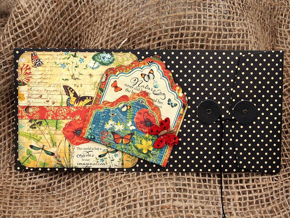 The next page in the mini is a policy envelope.  Adhere a pocket tag from the Tags & Pockets as shown.