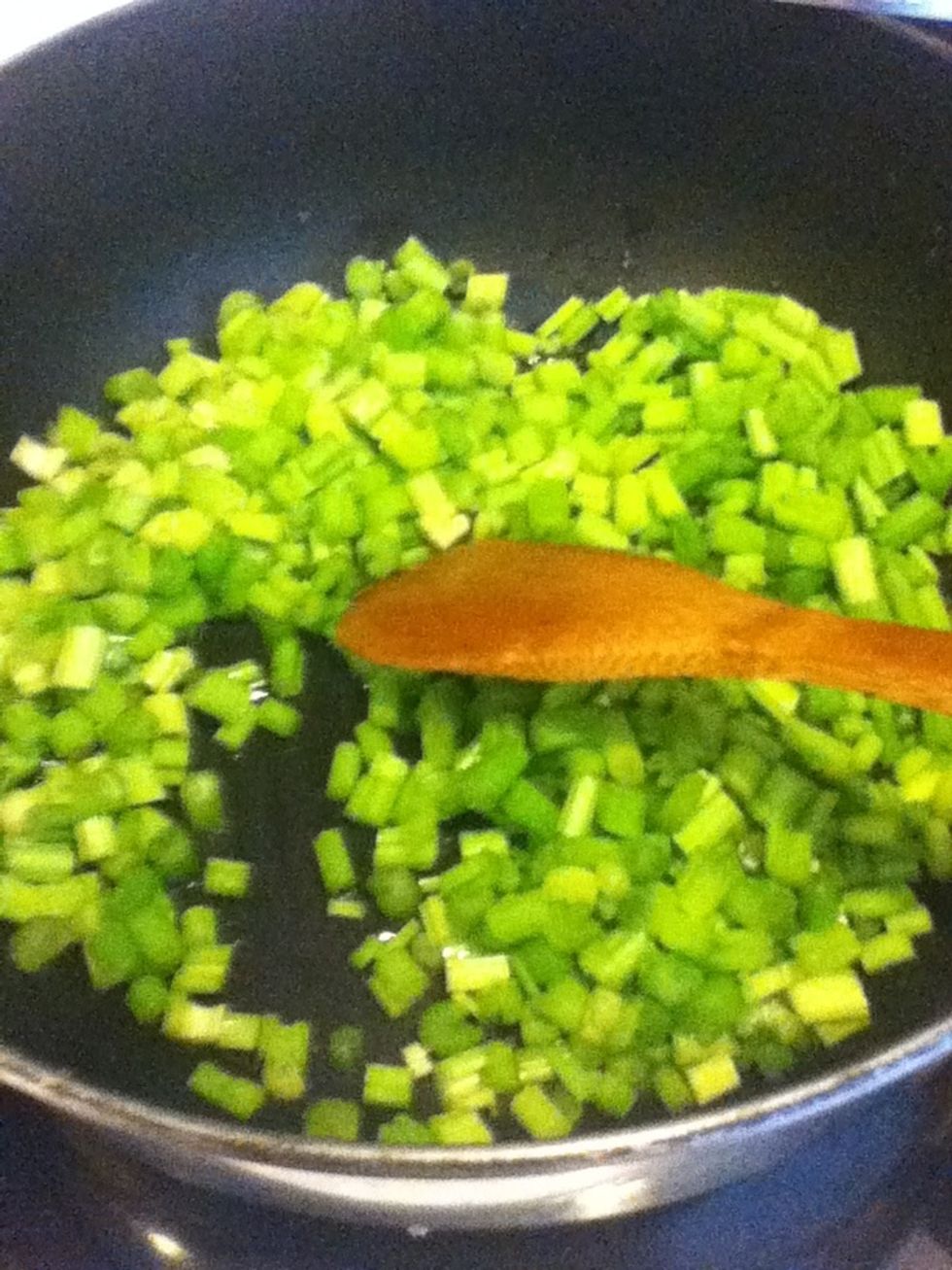 The oil is ready if when you add the celery you hear sizzling sounds.  If you need, turn up the heat.  Cook the celery for a minute, stirring frequently.