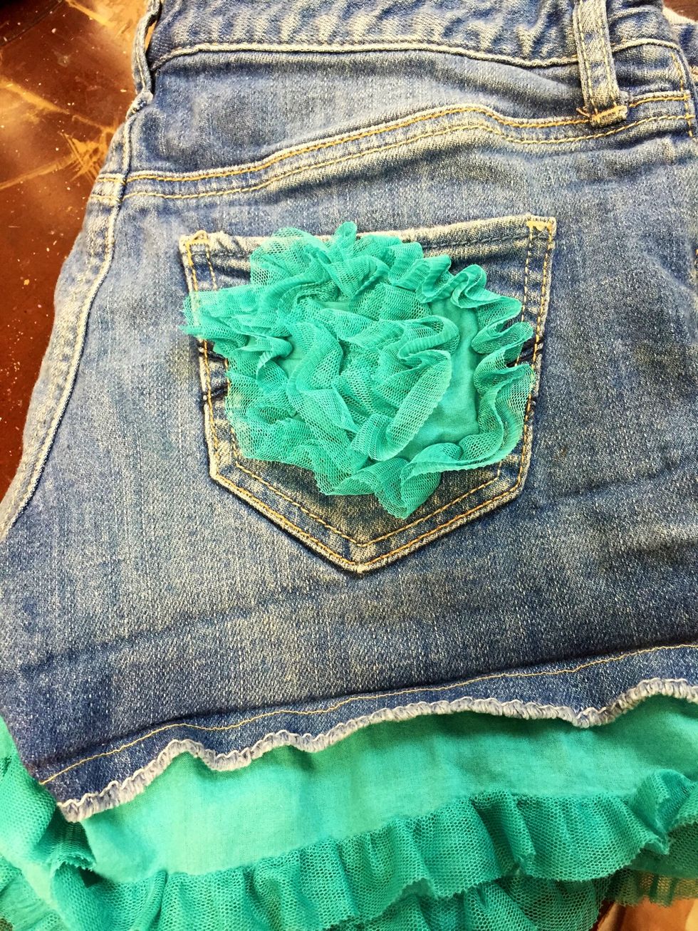 The old dress had some tulle rosettes and we decided to embellish the overalls to make a new style! You can hand stitch these details!