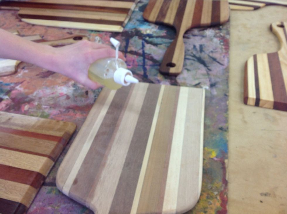 The olive oil is used so: the board will not burn and the pizza doesn't get contaminated