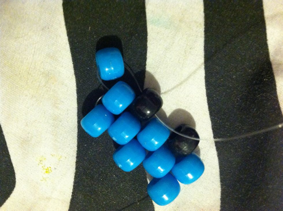 The Once Your String Is Coming Out Of That Last Blue Bead Add Another Blue Bead And String It Up Through That Black Bead At The Top .