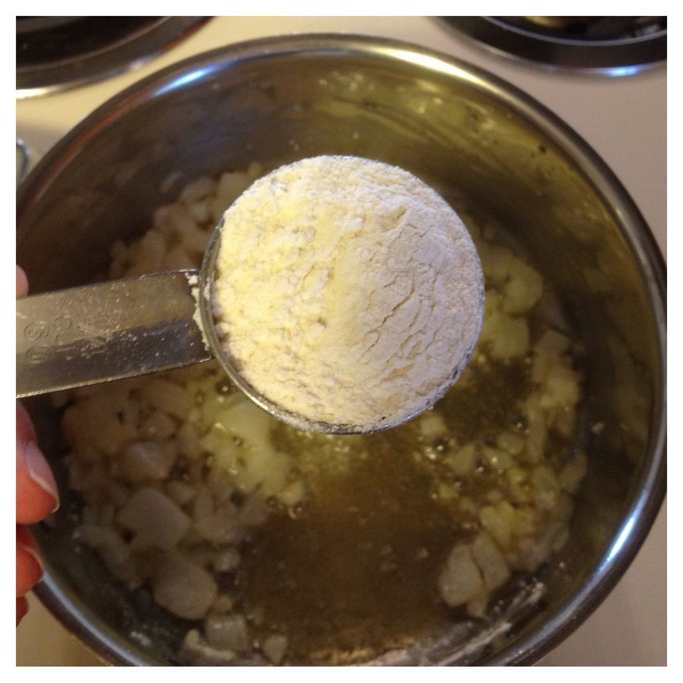 The onions should be cooked now. Add 1/4 cup flour to the onion/butter mixture and stir well.