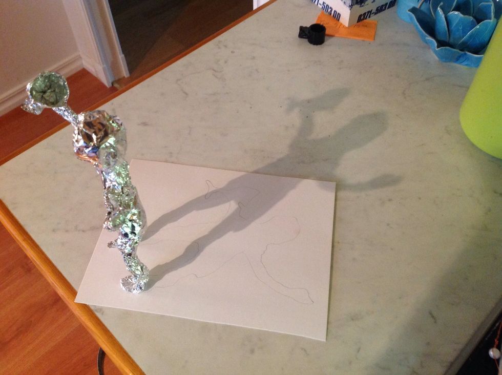 The other way you can do this is to put the figure far away from a lamp, the shadow will be long and won't fit the paper. But if you look at the next picture I'll show you what to do :-)