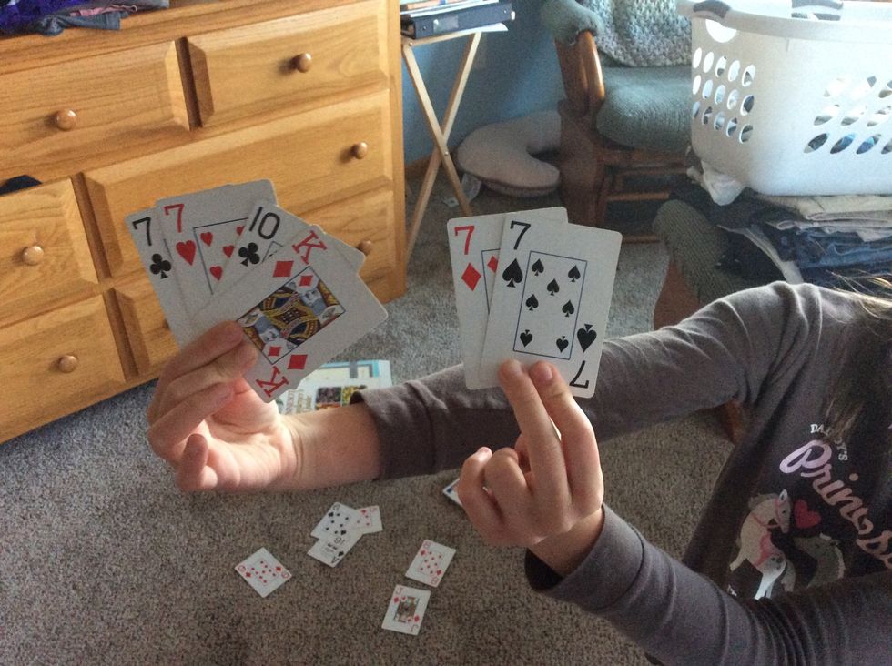 The person to the dealer\u2019s left looks at the card they are given then decides if they want to keep it because they think they will get, or already have, the three other cards that match.