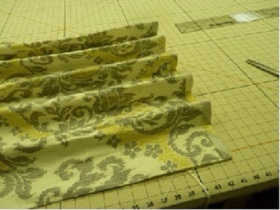 The pleats are formed by pulling the cords. Manipulate the fabric so that the areas between the pleats is flat.