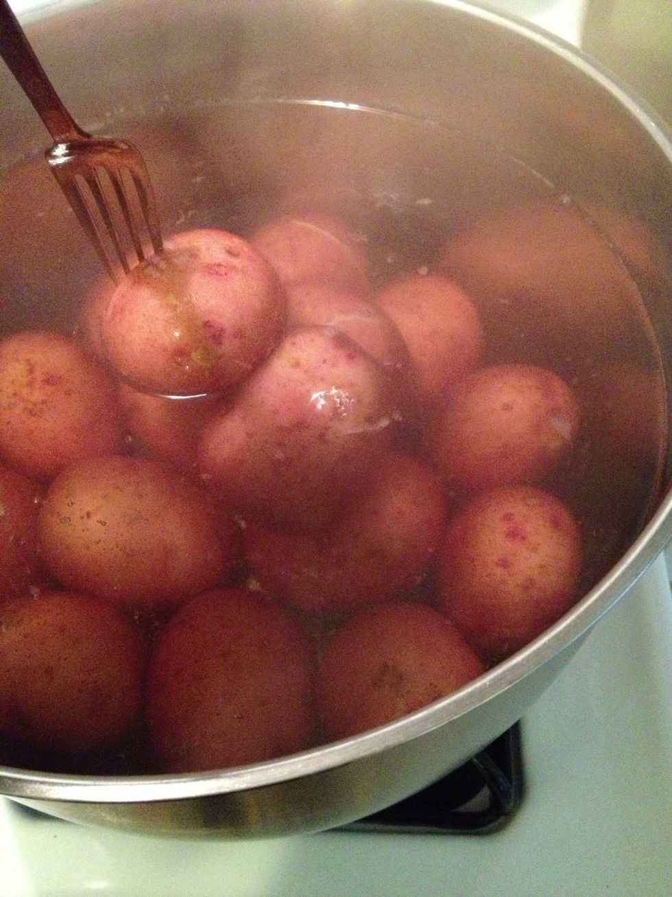The potatoes are done when you put a fork in them and they are softened. They should slide off the fork just when they are pulled above the surface if the water.