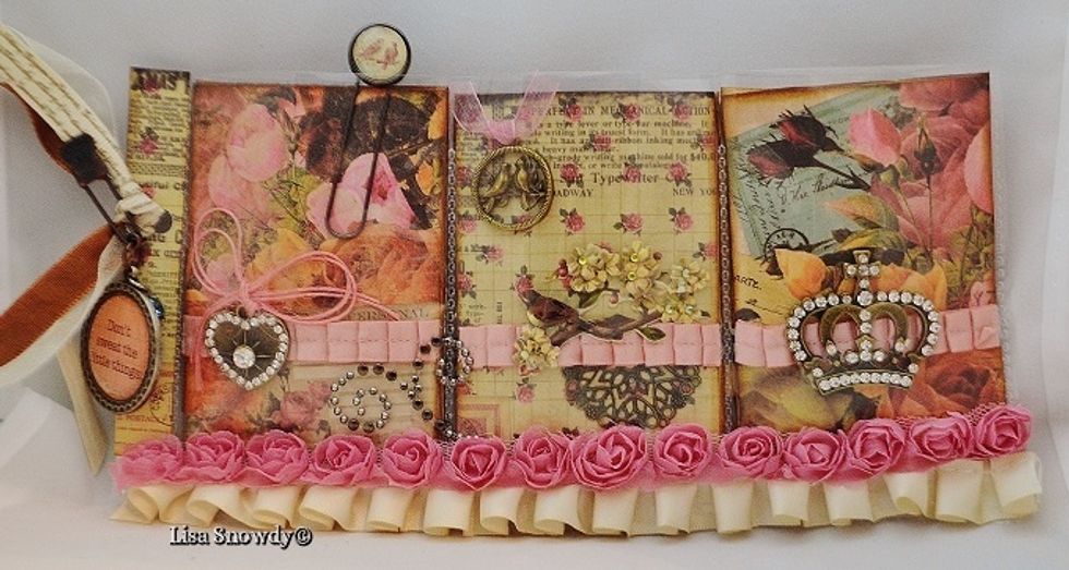 The pretty ivory satin trim is by Webster's Pages and the rose trim is by May Arts. I cut 1/2" below the top row of pockets so I could add my trim with double stick tape. It adds to the shabby feel!