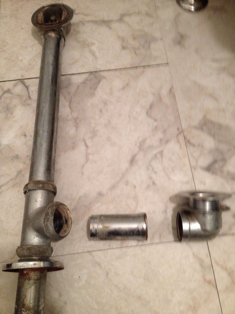 The problem - the small horizontal tube broke where it connected to the drain (right). When I tried to remove it I crimped the connector to the down pipe, meaning a full replacement was needed.