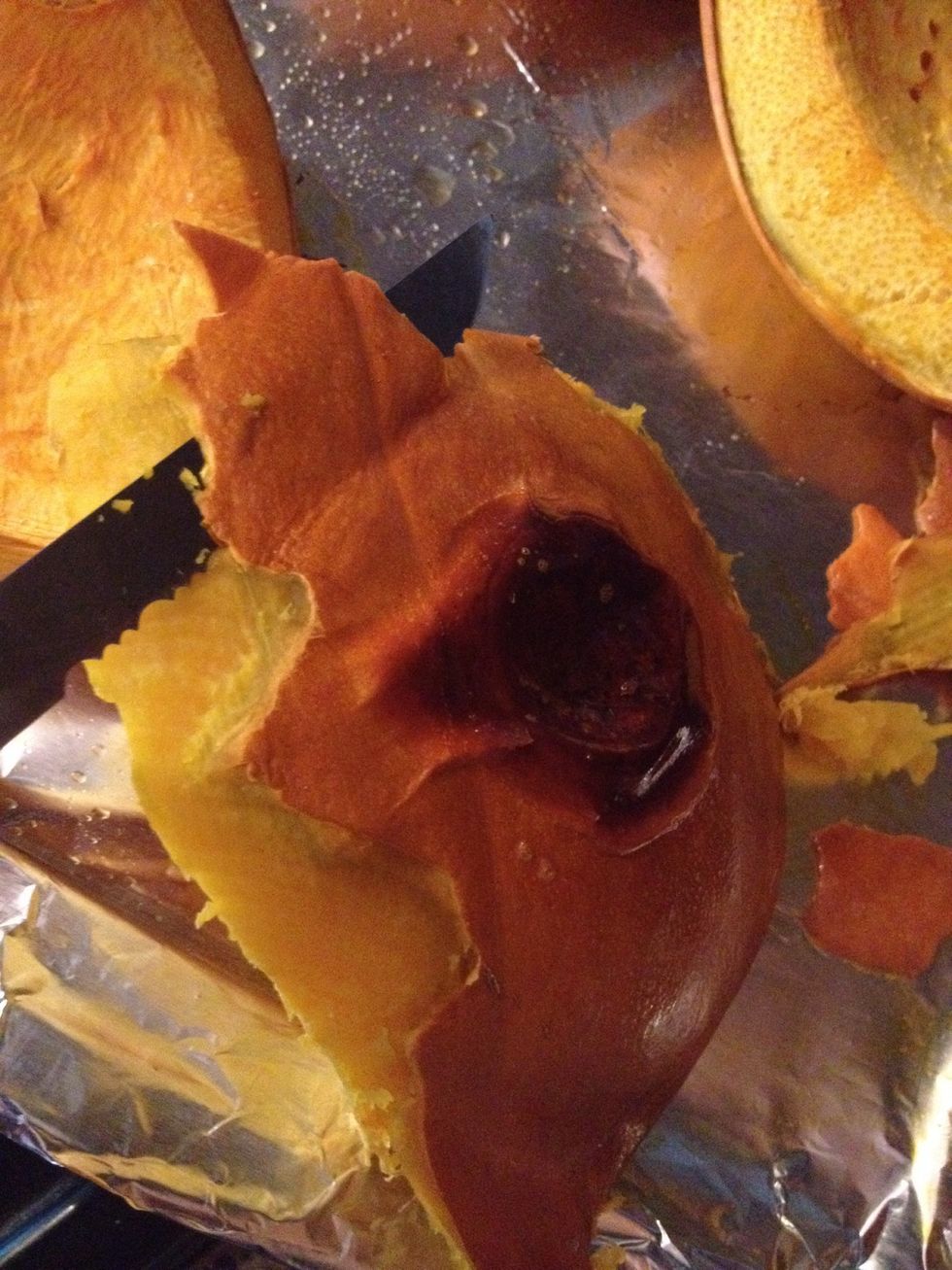 The pumpkin finished roasting so now it needs the skin off.