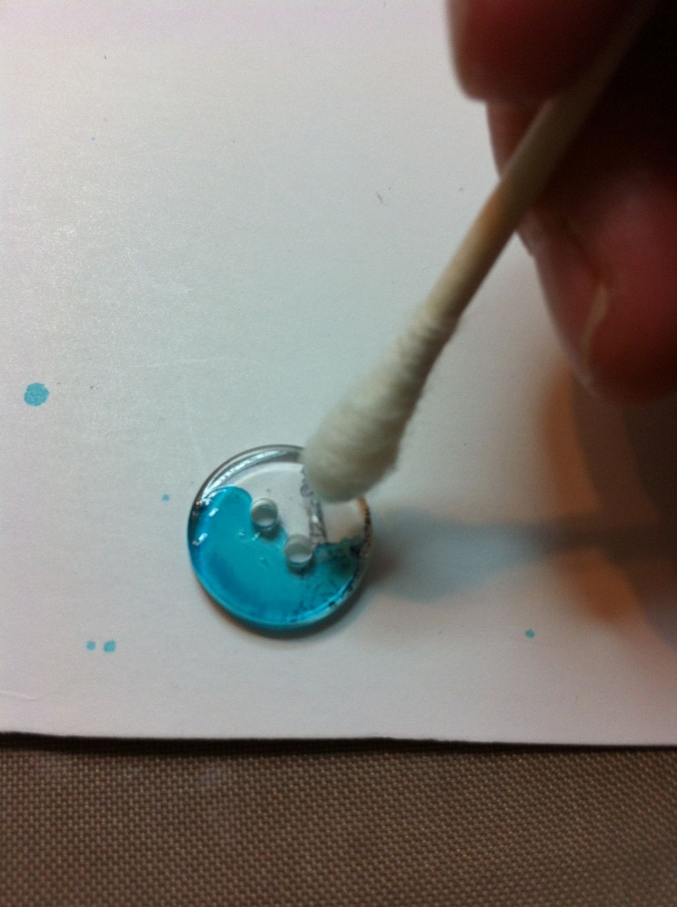 The q-tip has some rubbing alcohol on it.