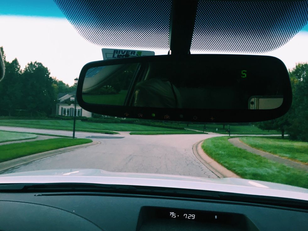 The rear view mirror is very useful when you are backing out and switching lanes. This mirror is placed over the dashboard and in front of the windshield. It is very important that you adjust it.