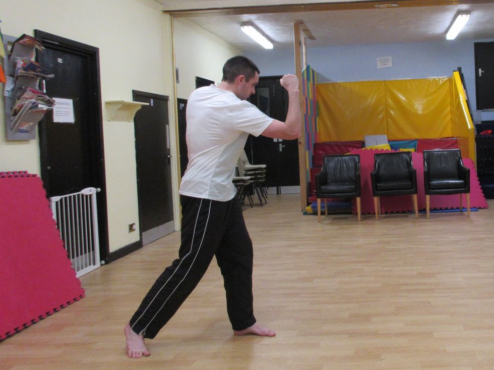 The reverse hand upper cut is more powerful. The technique is the same, except I twist my body across to reach the target. My weight is rooted to the front foot as I lean in.