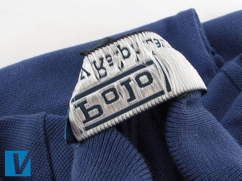 The reverse of a collar label on a Polo by Ralph Lauren polo features a difficult to copy thread.