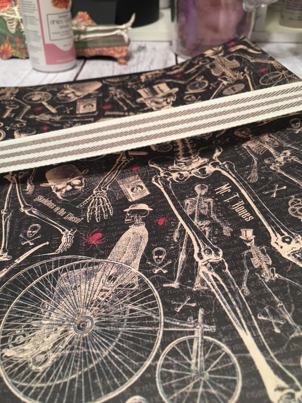 The ribbon will have a gap like this and the paper will be bowed slightly until you attach it down into the album.