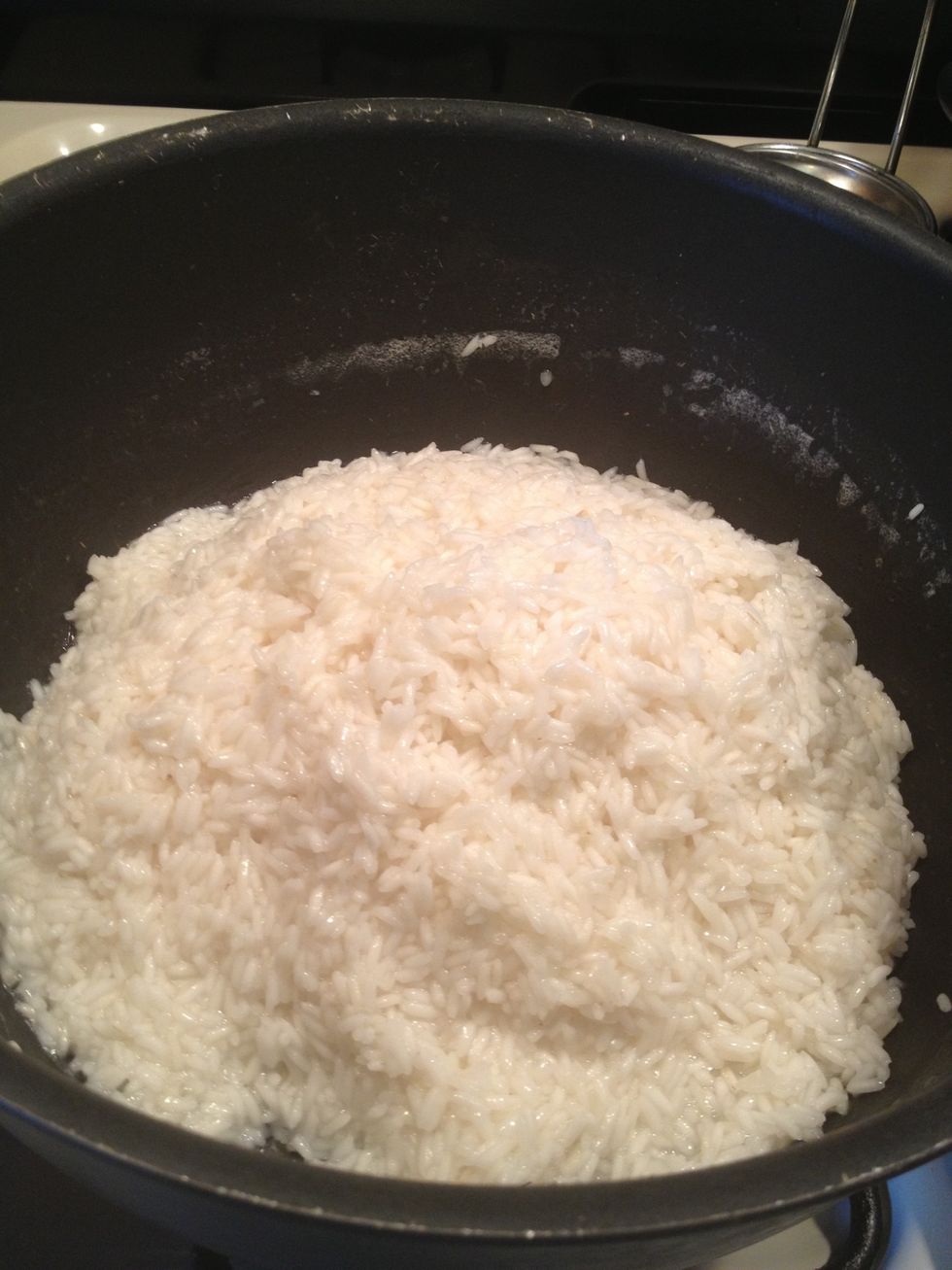 The rice has absorbed all the water, I like to mound it all in the middle. I will close the lid and lower the heat and cook for 20-25 min. In that time DO NOT open the cover!! It's a nono.