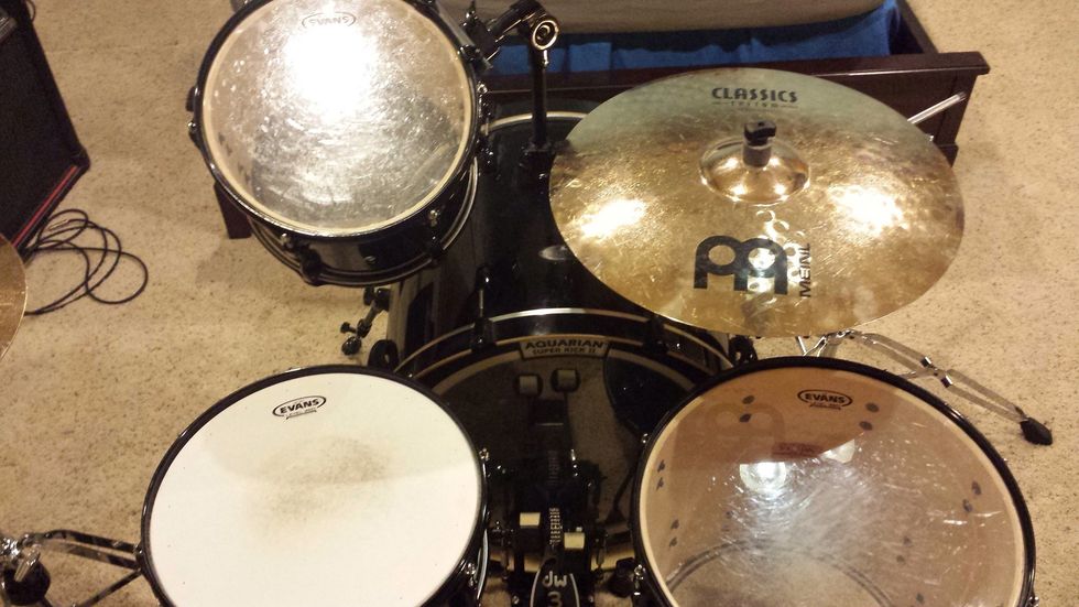 The ride cymbal is set up over the right side of the bass drum. It will likely overlap with the floor tom. All of your cymbals should be parallel to ground, and only as high up as needed.