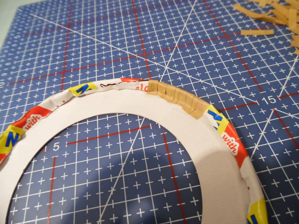 The rolled edge still needs a little shaping. Gumstrip to the rescue. Work around the edge of the brim wrapping and sealing with pieces of Gumstrip.