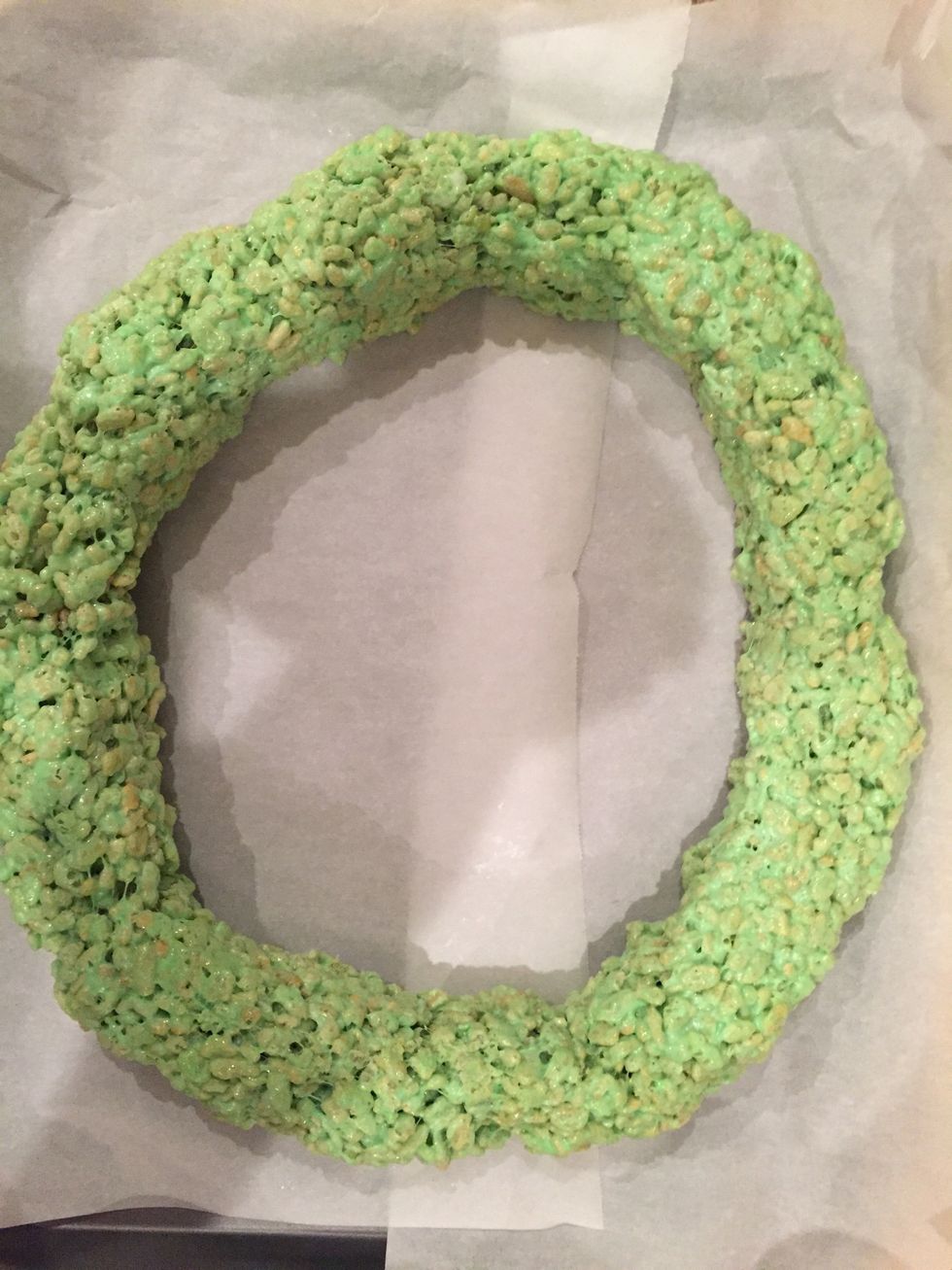 The round pan I had at the time was too small for the amount of Rice Krispies I was using so here's what I did. Placed some parchment paper and tried to make the rind as round and even as possible.