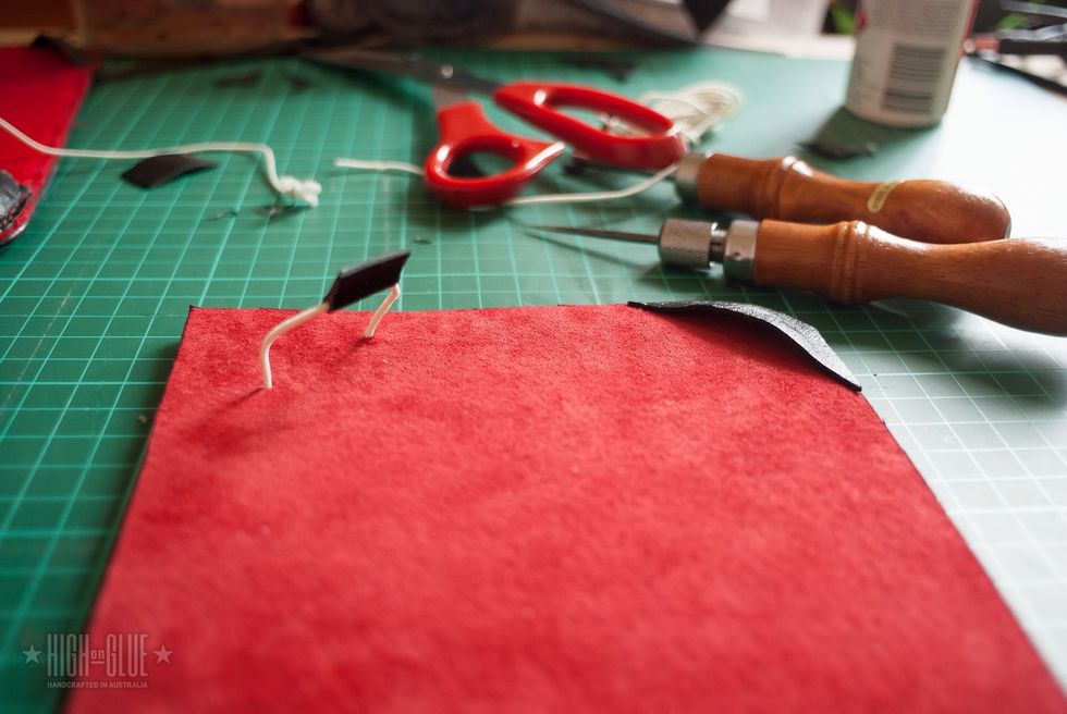 The rubber band will make it easier to put the Kindle in the case and the leather rectangle makes it easier to lift the rubber band and it helps keeping it in place on the device.