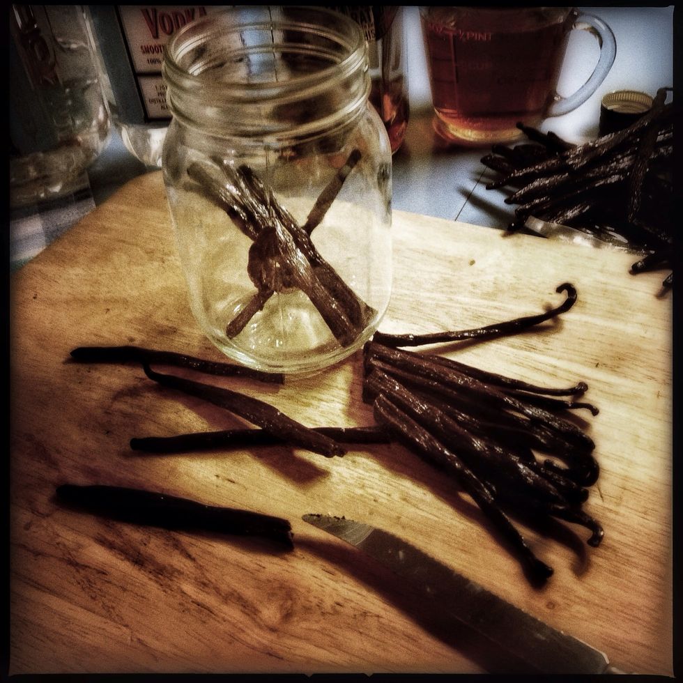 The rule is 5 beans / cup of alcohol.  For pint jars I use 11 beans cut in half.  Slit all of the beans lengthwise, to expose the insides then drop them in the jar.  Cover completely with alcohol.