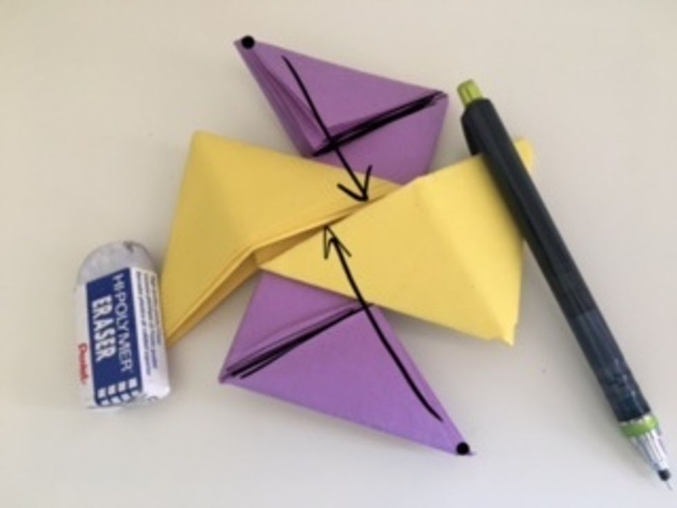 The S piece has 2 "pockets." Fold the end corners of the Z pieces into the pockets. They should be on the creases the black lines are on.